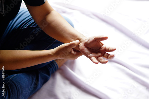 Close up man holds a hand on his pain wrist. painful, suffuring from syndrome, aged or long time using wrist or hands. Concept, health problems, carpal athristis or rheumatism. 