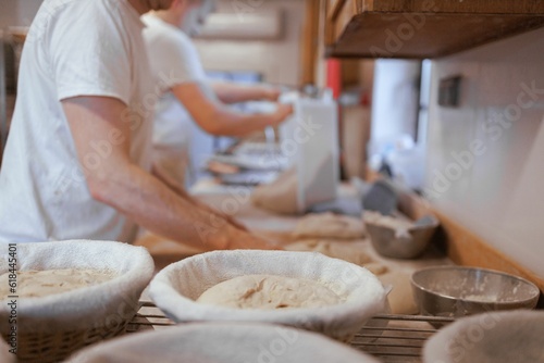 Baker working in the kitchen, preparing loaves of bread