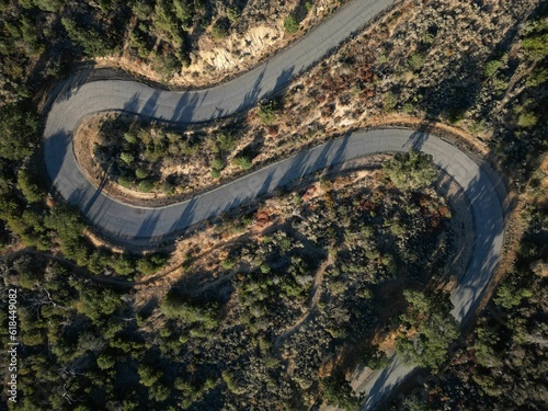 An aerial shot of Old pine canyon road between the green lush trees