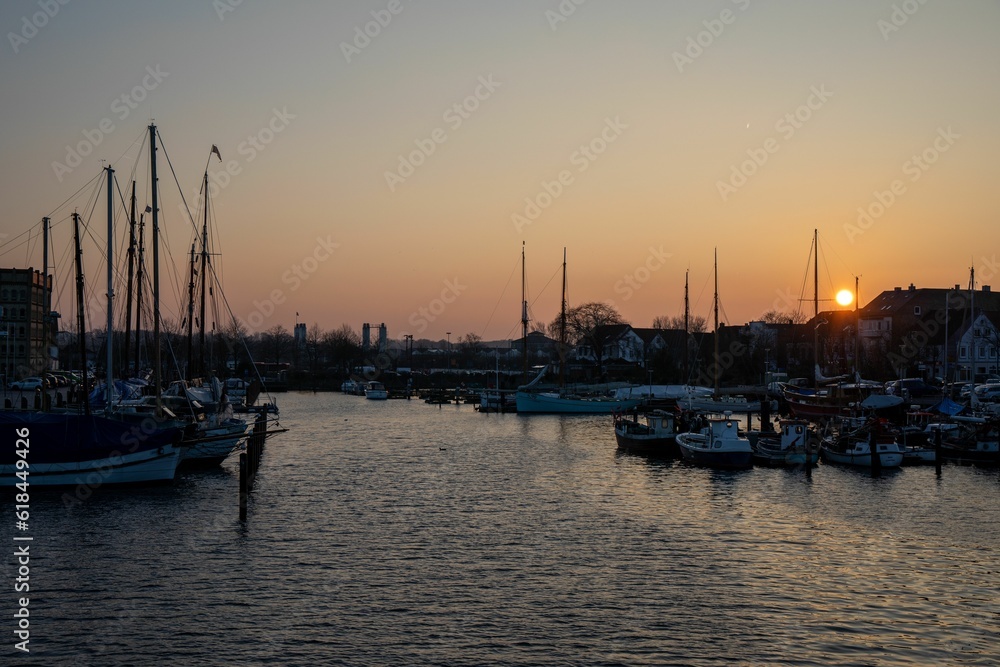 Picturesque sunset scene of a bay with boats floating in the tranquil waters
