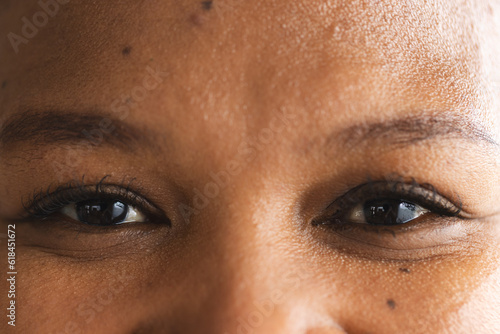 Close up of eyes of happy african american woman looking at camera photo
