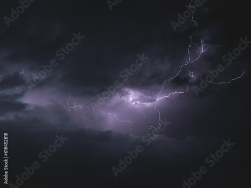 Beautiful shot of striking lightning in a dark purple sky
