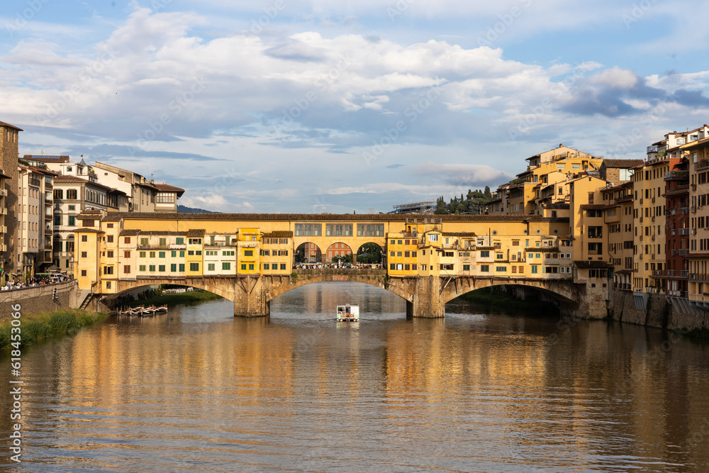 Evening sun over Ponte Vecchio, the historic old bridge over Arno river in Florence, Tuscany, Italy is popular tourist destination