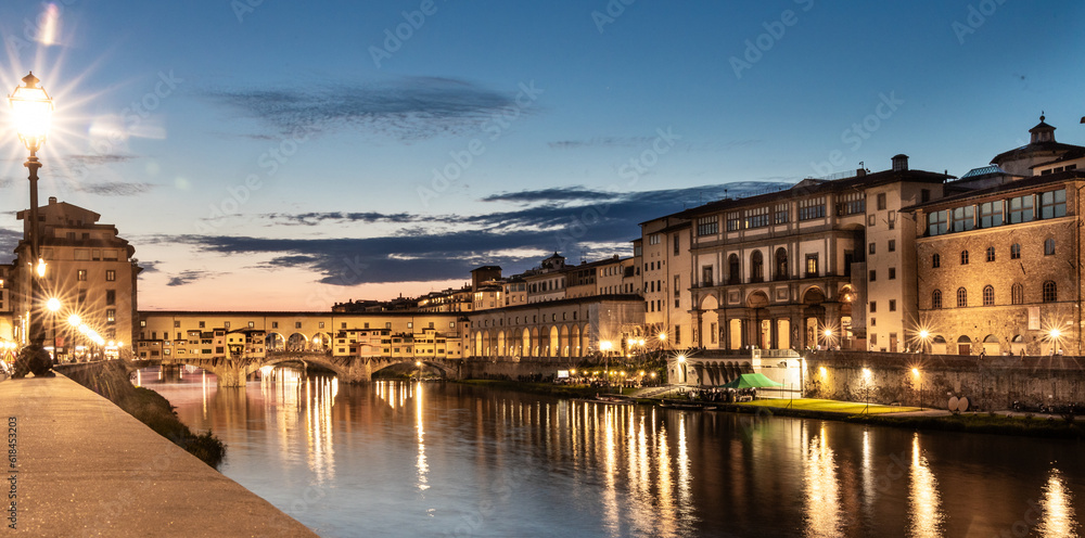 Night scene of the Ponte Vecchio, the historic bridge over Arno river in Florence, Tuscany, Italy that is popular tourist destination