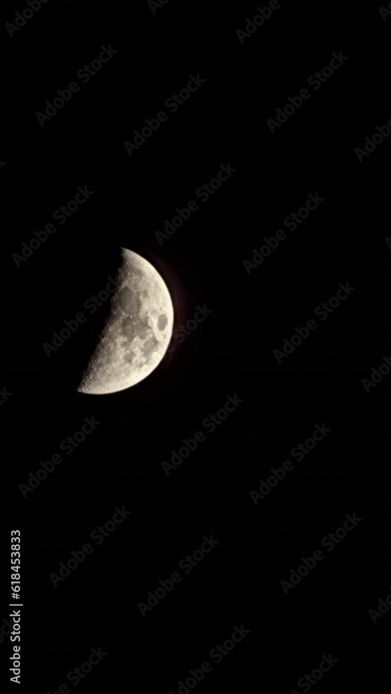Stunning image of a tranquil night sky, featuring a half moon Stunning image of a tranquil night sky, featuring a half moon