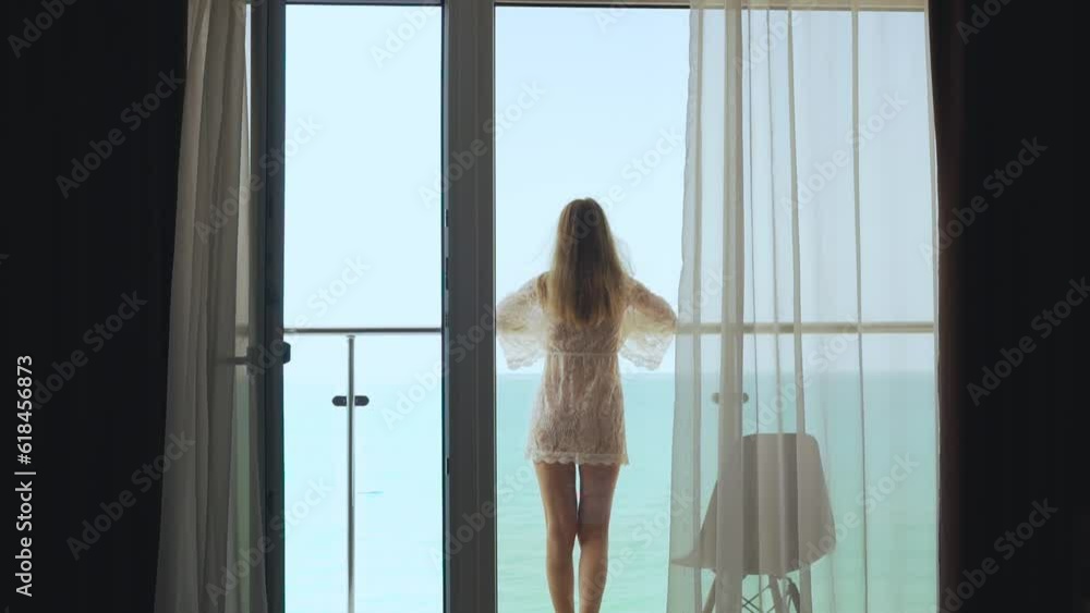 Vacation Female Steps Out On The Balcony And Admires The Beautiful Ocean View On A Sunny Summer Day. Travel, Summer Holidays, Tourism. Vacation Female Steps Out On The Balcony And Admires The Beautiful Ocean View On A Sunny Summer Day. Travel, Summer Holidays, Tourism.