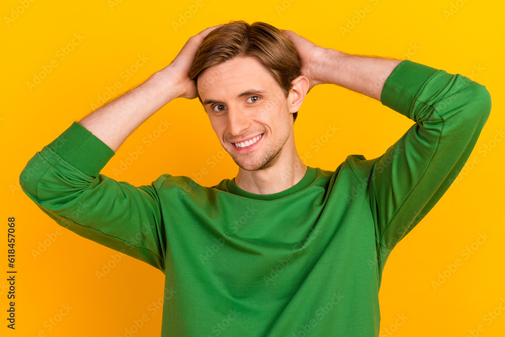 Photo of young guy happy positive smile hands touch hair barber shop lotion isolated over yellow color background Photo of young guy happy positive smile hands touch hair barber shop lotion isolated over yellow color background