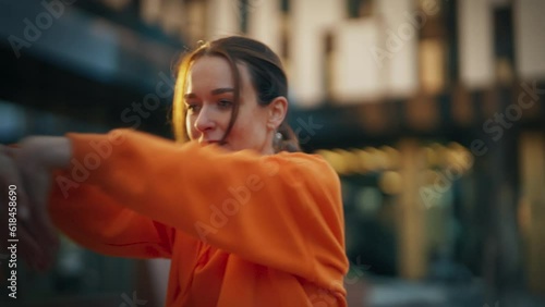 Close-Up Shot of Young Stylish Female Hip Hop Dancer Freestyling On City Street. Professional Newstyle Performer Doing Improvisation In Urban Environment. Caucasian Woman Practicing Choreography.