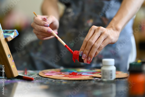 Closeup view of artist mixing color oil painting on palette. Art, hobby and leisure activity concept