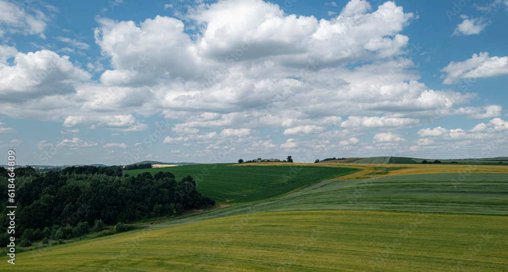 Spring panorama of a field with a view of cumulus clouds Spring panorama of a field with a view of cumulus clouds
