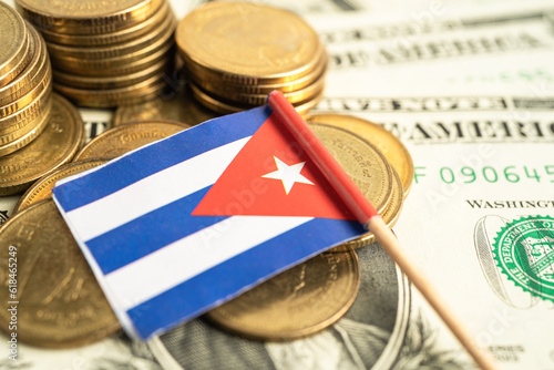 Canvas Print Stack of coins with Cuba flag and US dollar banknotes.