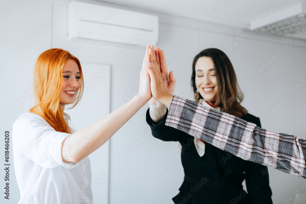 Hands, a group of diverse business women cheering and motivating each other at work. Colleagues succeed through teamwork and collaboration, businesswoman hands together.