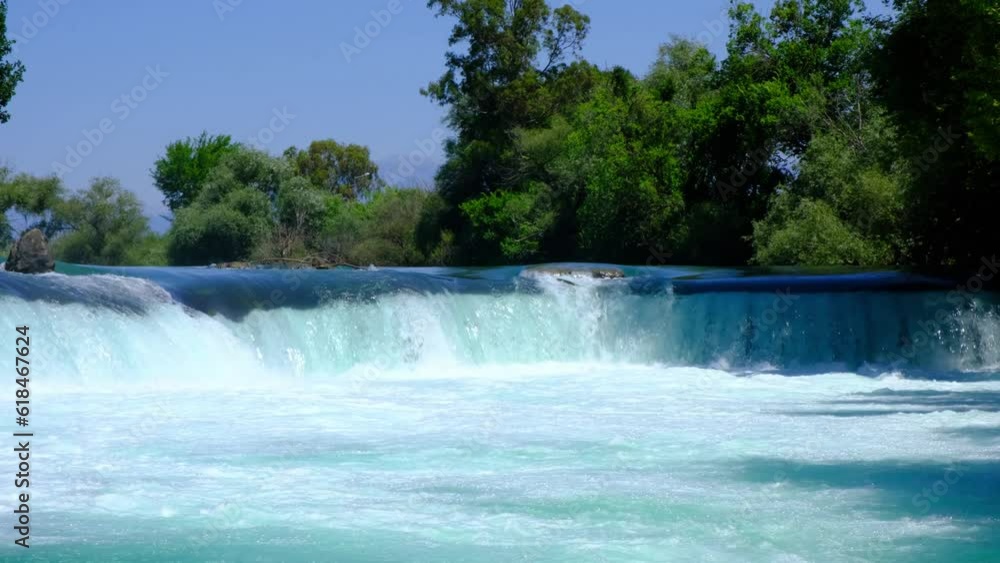 Manavgat waterfall Manavgat River is near the city of Side, 3 km north of Manavgat in Turkey. A wide stream of water falls from a low height. Manavgat waterfall Manavgat River is near the city of Side, 3 km north of Manavgat in Turkey. A wide stream of water falls from a low height.