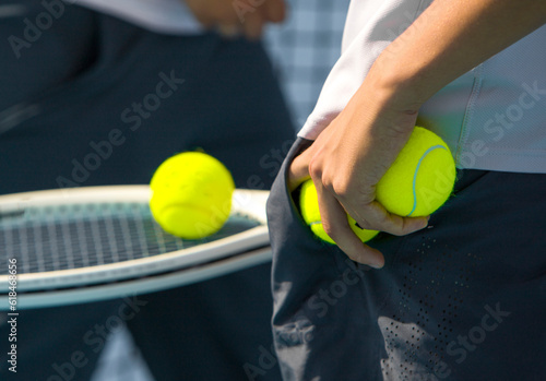 Close-up of a tennis player's hand holding a tennis ball and racket © Павел Мещеряков