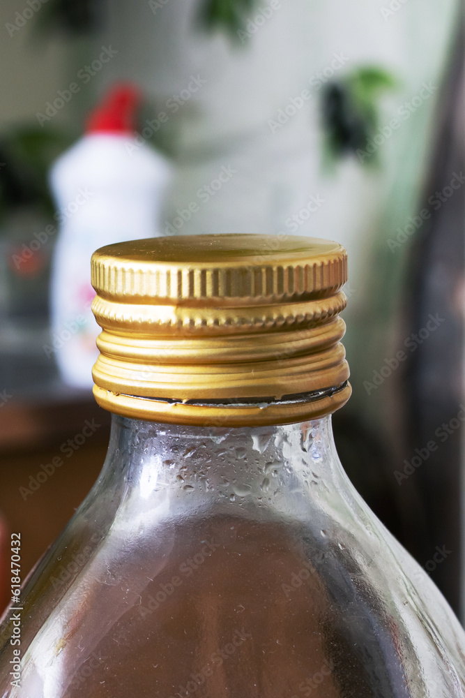 Bottle with oil on background of dishes and sinks