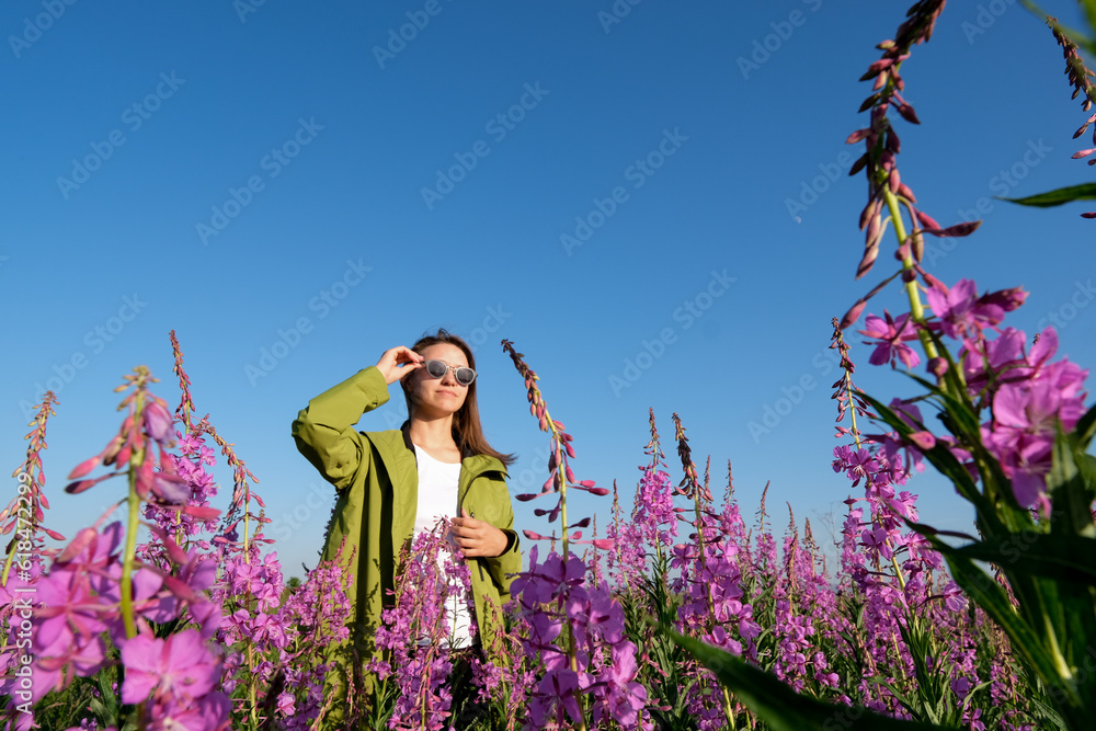 smiling young woman with hat on willow-herb flowers field. happiness, nature, summer, vacation concept smiling young woman with hat on willow-herb flowers field. happiness, nature, summer, vacation concept