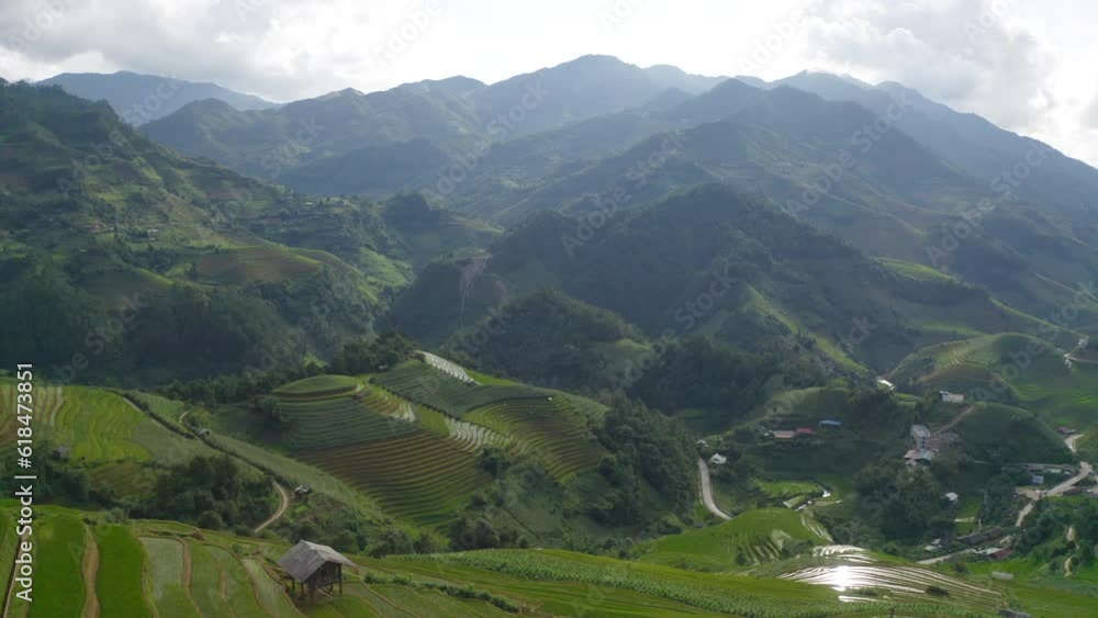 Aerial top view of fresh paddy rice terraces, green agricultural fields in countryside or rural area of Mu Cang Chai, mountain hills valley in Asia, Vietnam. Nature landscape background. Aerial top view of fresh paddy rice terraces, green agricultural fields in countryside or rural area of Mu Cang Chai, mountain hills valley in Asia, Vietnam. Nature landscape background.