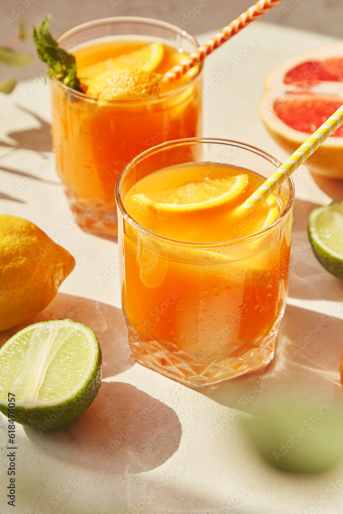 Fresh summer non alcoholic refreshing cocktail with orange, grapefruit, lemon and lime. Detox vitaminized beverage. Vertical photo Fresh summer non alcoholic refreshing cocktail with orange, grapefruit, lemon and lime. Detox vitaminized beverage. Vertical photo