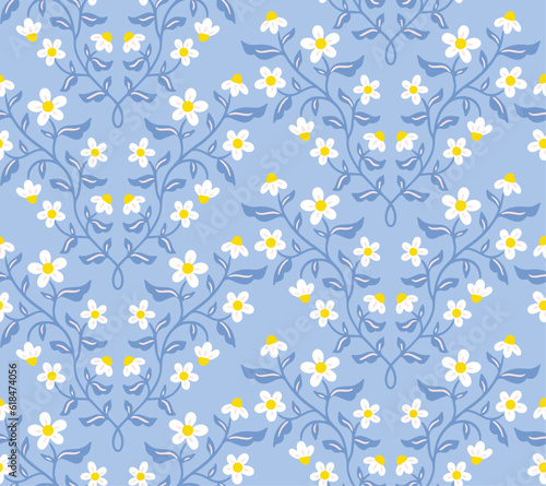 Seamless vector pattern with camomiles on blue background