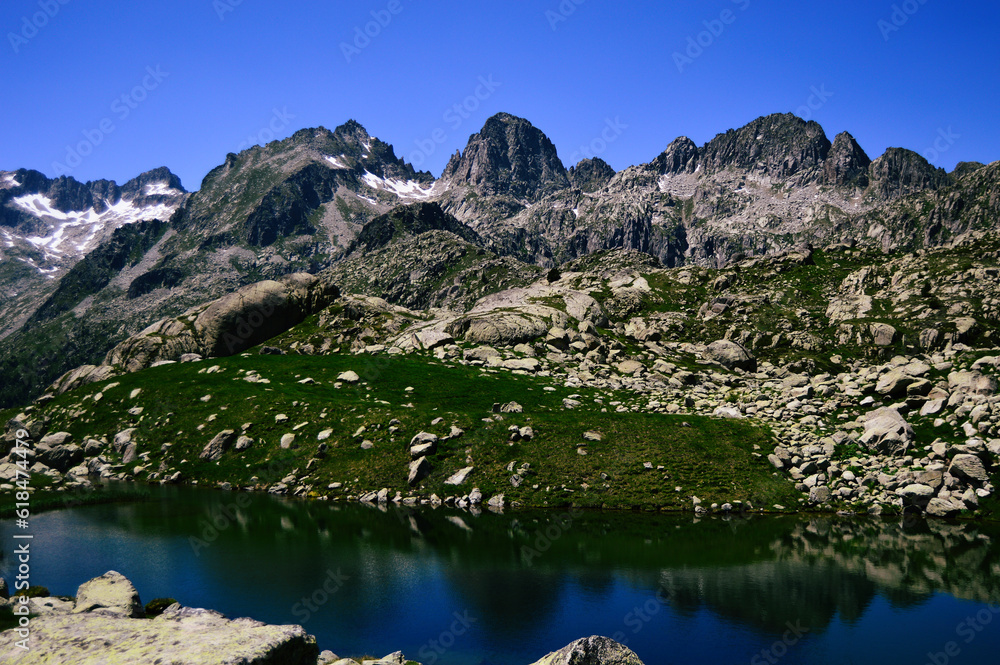 A pristine high mountain lake reflects the majestic beauty of a mountain range