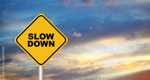 slow down sign on sky background