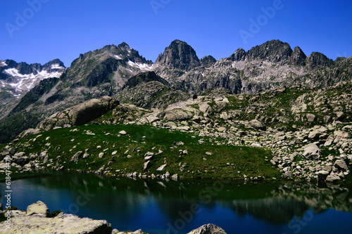 A pristine high mountain lake reflects the majestic beauty of a mountain range