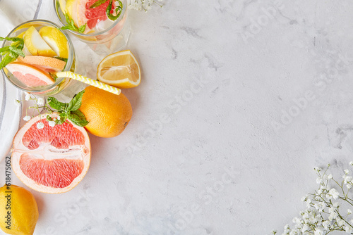 Top view of aesthetic summer cocktails with citrus fruits. Copy space. Vitaminized detox water. Low alcohol, zero proof drinks.