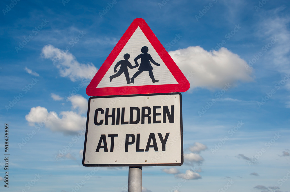 Children at play road sign against a blue sky Children at play road sign against a blue sky