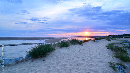 Fototapeta Naklejka Na Ścianę i Meble -  Sunset on the beach with dune gras.