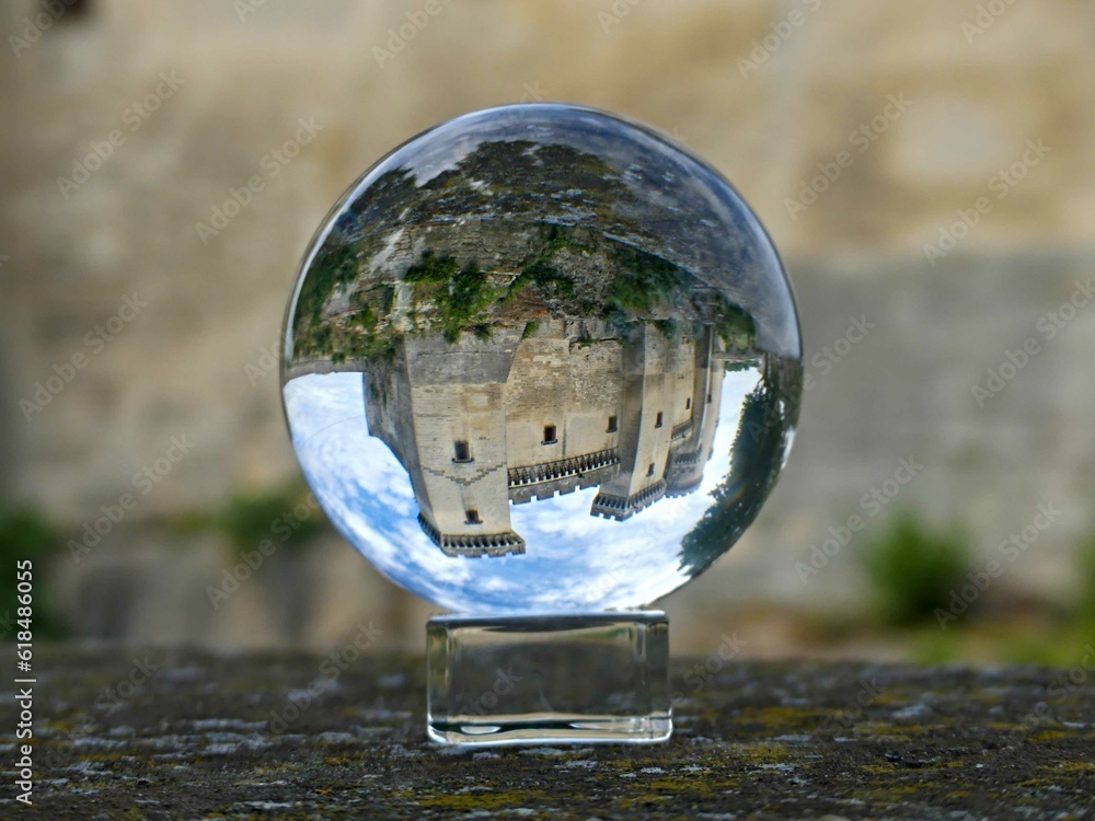 Tarascon, May 2023 : Visit the beautiful city of Tarascon in Provence - View on the castle Through a lens ball - obrazy, fototapety, plakaty 