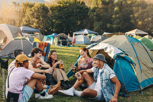 Festival camp conversations: Group of youthful friends bond over beer and laughter