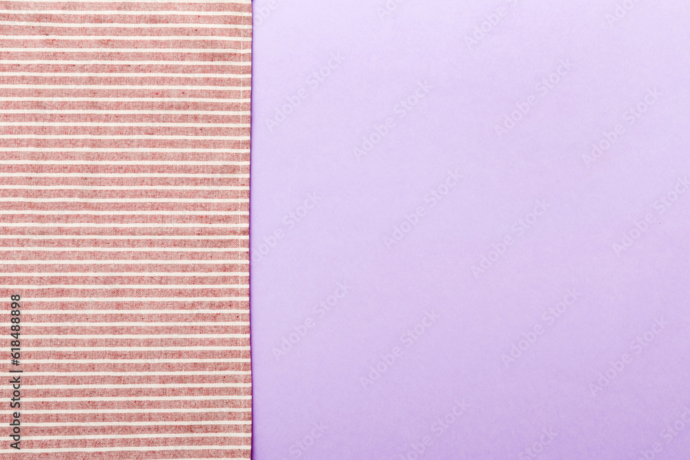 Fototapeta premium top view with red empty kitchen napkin isolated on table background. Folded cloth for mockup with copy space, Flat lay. Minimal style