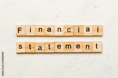 Financial statement word written on wood block. Financial statement text on cement table for your desing, concept