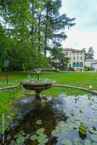 Parma, Italy: Fondation Magnani Rocca. Beautiful building of museum across garden and fountain with waterlilies photo