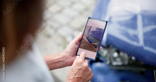 Person Taking Picture Of Damaged Car