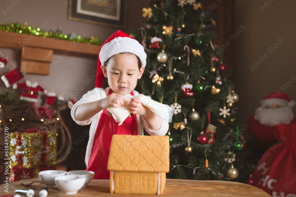 young girl making gingerbread house at home young girl making gingerbread house at home