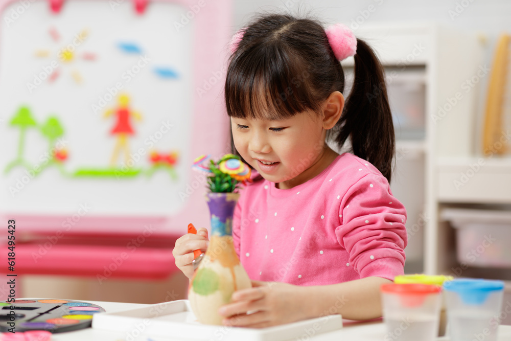 young girl making flower craft at home young girl making flower craft at home