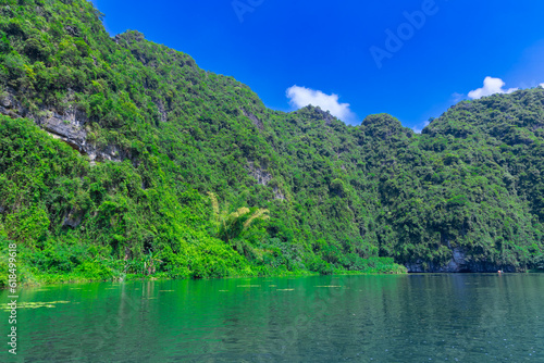 Trang An River Ninh Minh and Bai Dinh Mountain ranges in Vietnam only 3 hours drive from Hanoi. Beautiful winding river and large rising mountains. boats going through the caves in the river