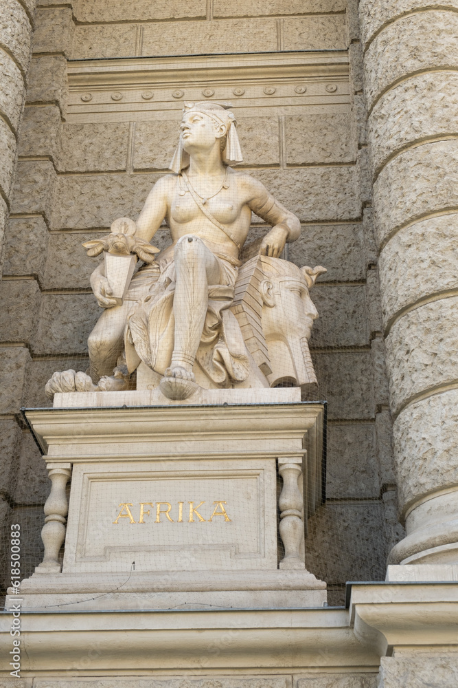 Sculpture woman and sphinx on a building in Austria in Vienna, text in German Afrika