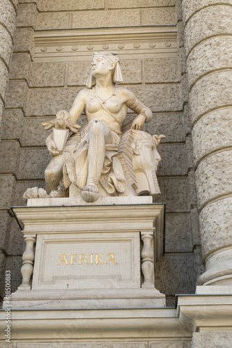 Sculpture woman and sphinx on a building in Austria in Vienna, text in German Afrika