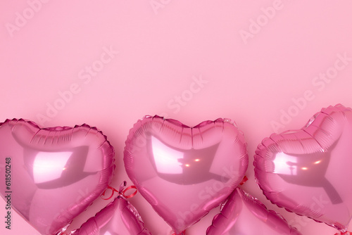 Pink inflatable foil balloons in a heart shape. Monochrome festive concept with copy space.