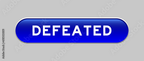Blue color capsule shape button with word defeated on gray background