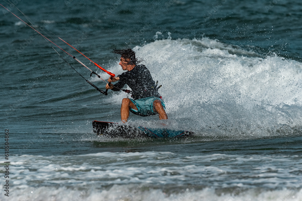 Fototapeta premium A kite surfer rides the waves
