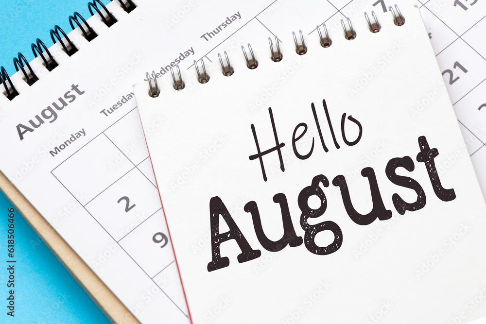 HELLO AUGUST words in notebook on calendar. HELLO AUGUST words in notebook on calendar.