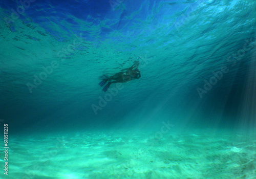 snorkeling in the crystal clear waters of the caribbean sea on an island