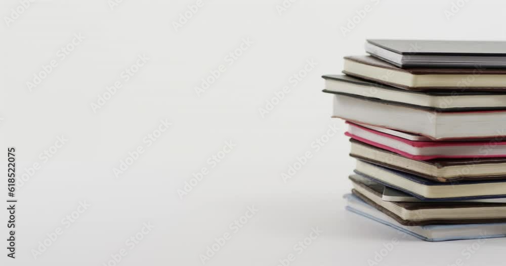 Close up of stack of books with copy space on white background