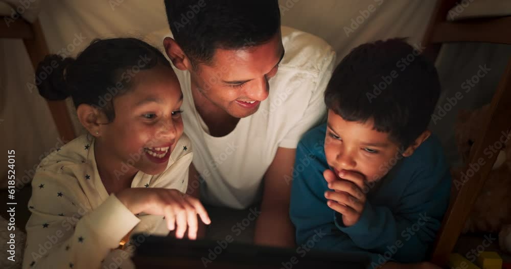 Night, father and children on tablet in tent watching movies, online games and cartoon. Happy family, blanket and dad with kids and fairy lights in bedroom on digital tech for bonding, relax and love Night, father and children on tablet in tent watching movies, online games and cartoon. Happy family, blanket and dad with kids and fairy lights in bedroom on digital tech for bonding, relax and love