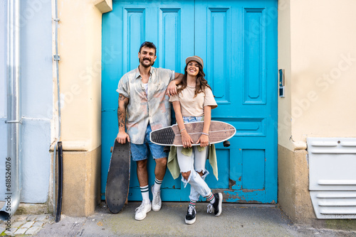Photography Portrait young couple with skateboard and longboard having fun outdoors