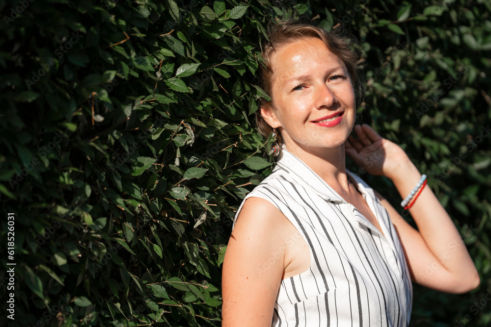 Portrait of a young blonde woman on a green background with space for text. Portrait of a young blonde woman on a green background with space for text.