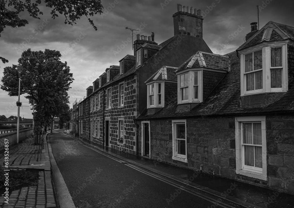 2023-06-11 A ROW OF 2 STORY OLD HOMES WITH A CLEAR STREET AND CLOUDY SKY IN INVERNESS SCOTLAND 2023-06-11 A ROW OF 2 STORY OLD HOMES WITH A CLEAR STREET AND CLOUDY SKY IN INVERNESS SCOTLAND